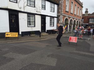 A reveller dances in the empty street by the road closed and diversion signs